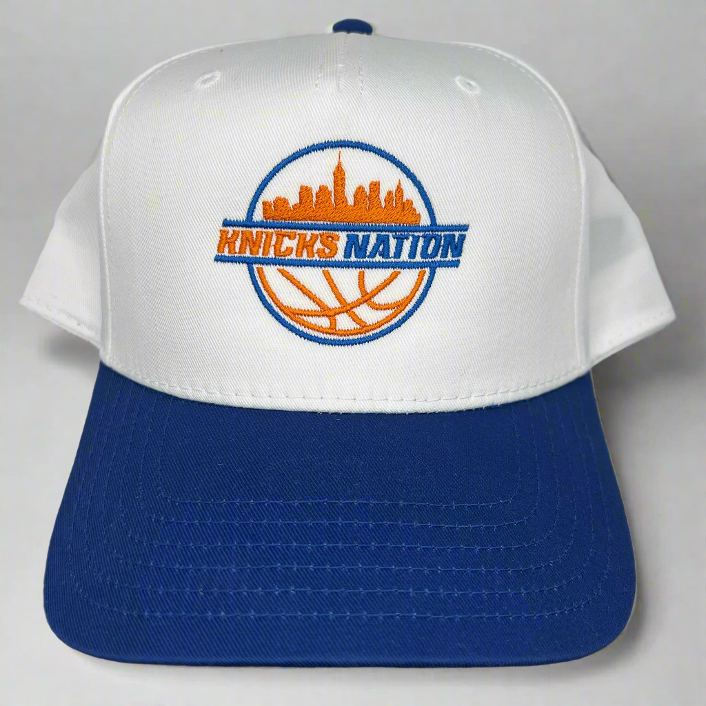 White and blue cap with 'Knicks Nation' logo on a light gray background
